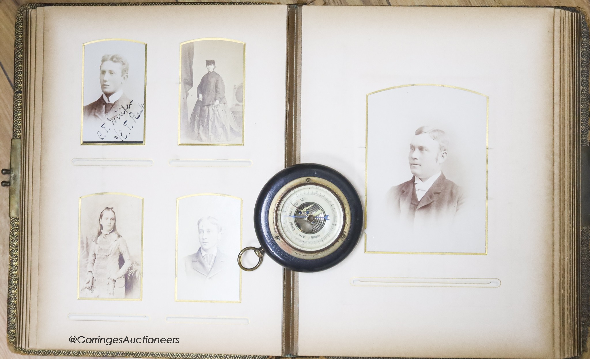 A Victorian monochrome photograph album and an aneroid barometer